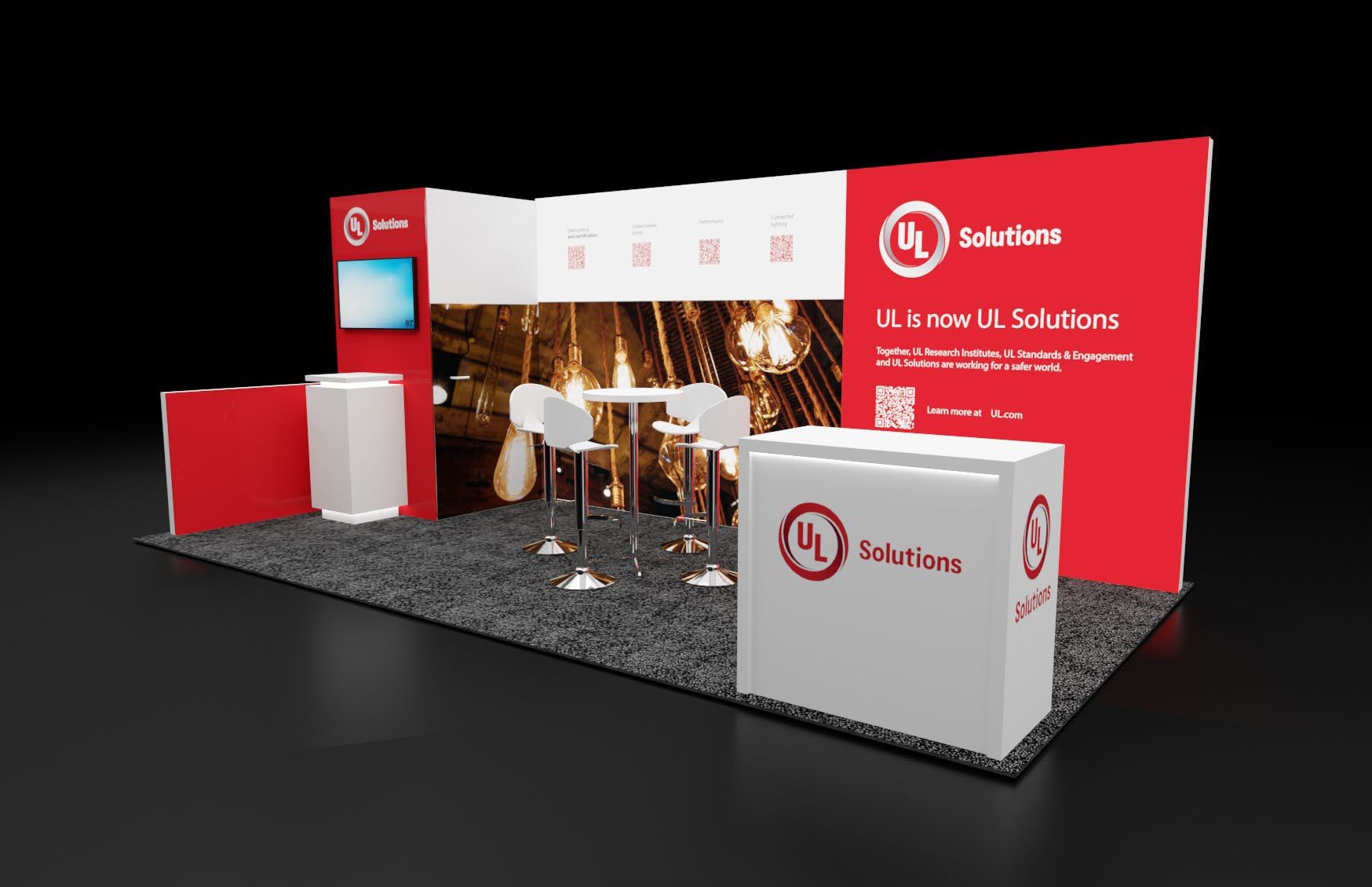 Exhibition booth with red and white UL Solutions branding. It features a table with white chairs, a screen, and industrial light bulb decor, set on a dark carpet.