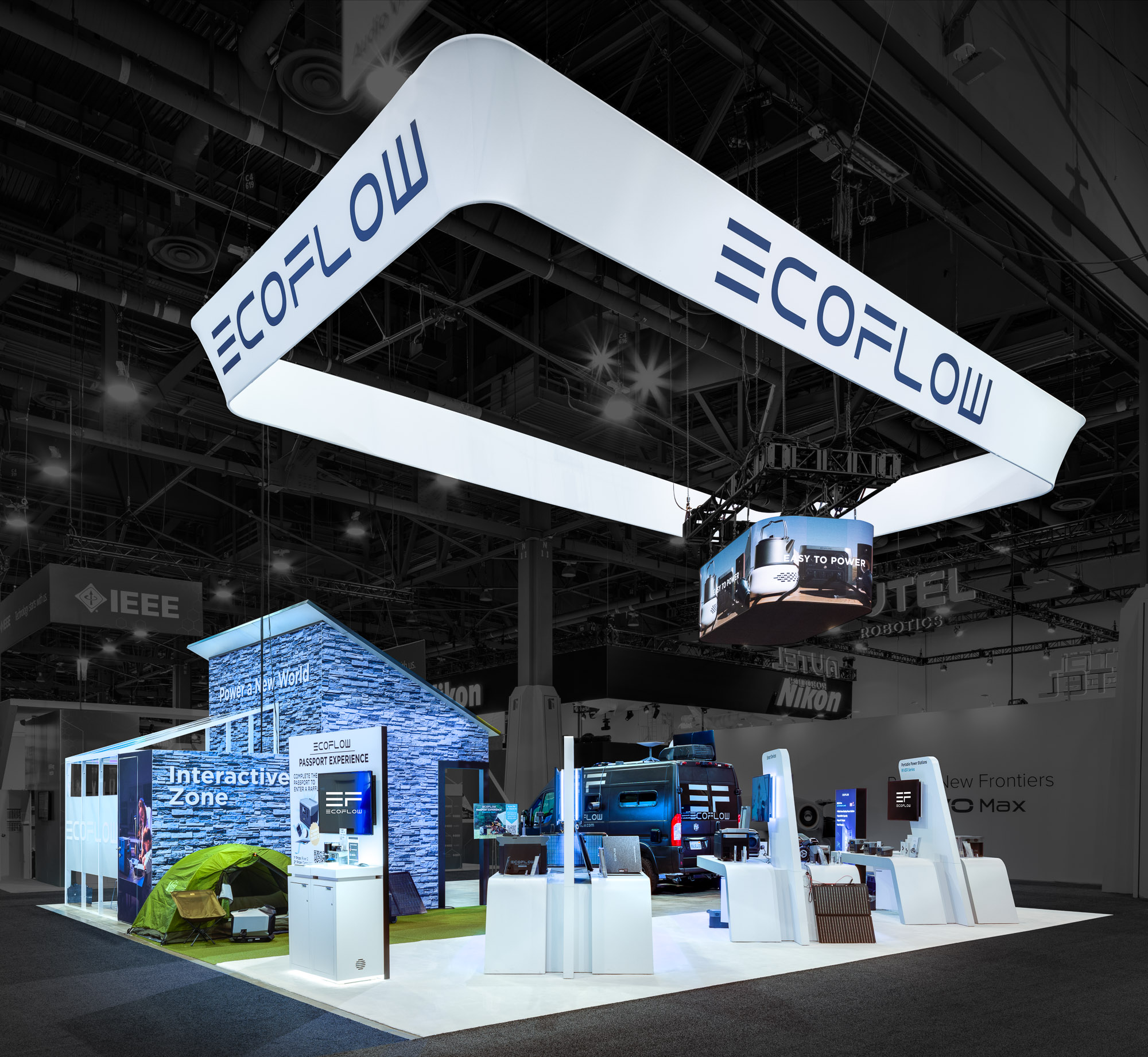Exhibition booth for EcoFlow featuring an illuminated overhead sign, interactive zone, and modern displays with tech devices