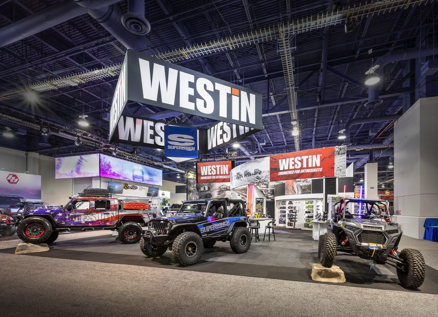 Exhibition booth displaying rugged off-road vehicles under prominent "Westin" signage