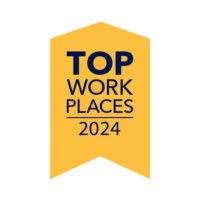 Awards & Associations Yellow ribbon with "Top Workplaces 2024" in bold navy text, conveying recognition and achievement in workplace quality.